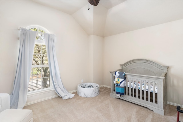 bedroom featuring a nursery area, baseboards, carpet, and vaulted ceiling