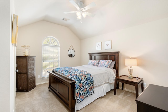 bedroom featuring visible vents, light carpet, baseboards, ceiling fan, and vaulted ceiling