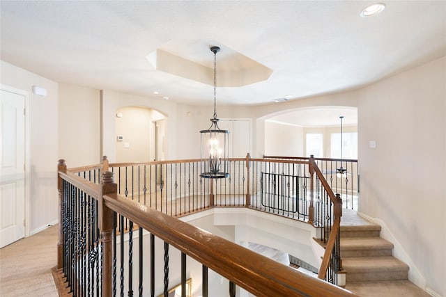 corridor featuring recessed lighting, an upstairs landing, arched walkways, and carpet floors