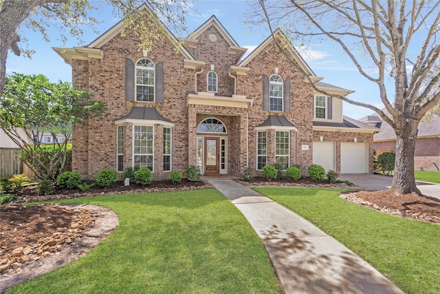 traditional-style home featuring driveway, brick siding, an attached garage, and a front yard