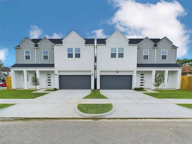 view of front of house featuring a front lawn, board and batten siding, and driveway