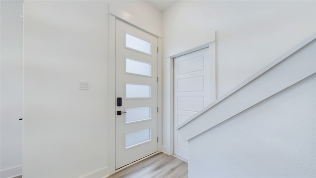 doorway to outside with light wood-style flooring