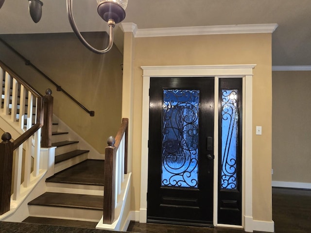 entrance foyer featuring baseboards, wood finished floors, and crown molding