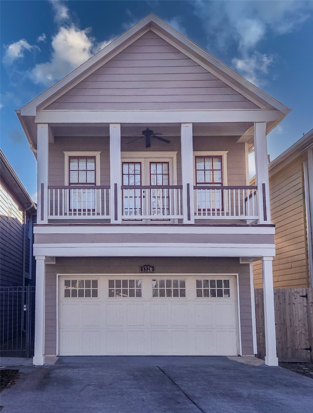 view of front facade featuring fence, a garage, and driveway