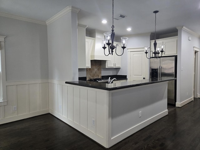 kitchen featuring visible vents, crown molding, dark countertops, dark wood-type flooring, and a chandelier