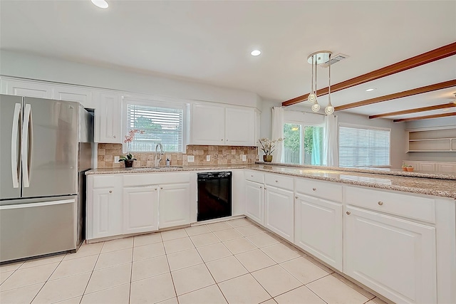 kitchen with backsplash, dishwasher, a wealth of natural light, freestanding refrigerator, and a sink