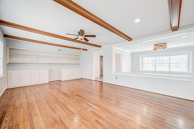 unfurnished living room with light wood-type flooring, beamed ceiling, visible vents, and ornamental molding