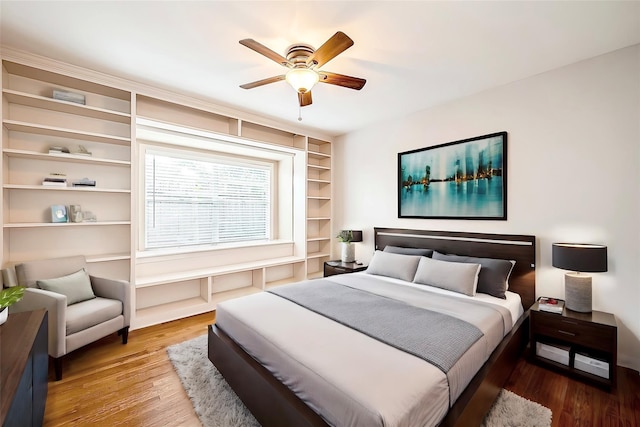 bedroom with ceiling fan and wood finished floors