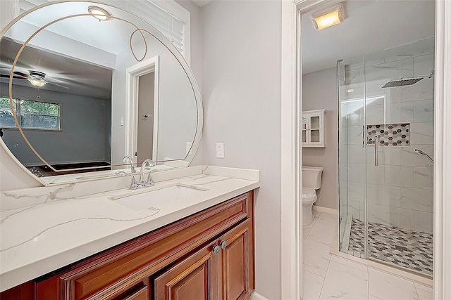 bathroom with vanity, baseboards, a stall shower, toilet, and marble finish floor