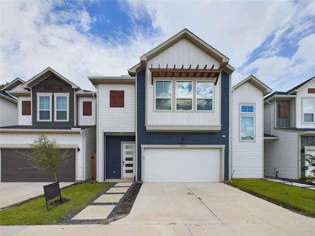 view of property featuring a garage, board and batten siding, and driveway