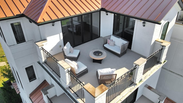 view of patio / terrace with an outdoor living space with a fire pit and stairs