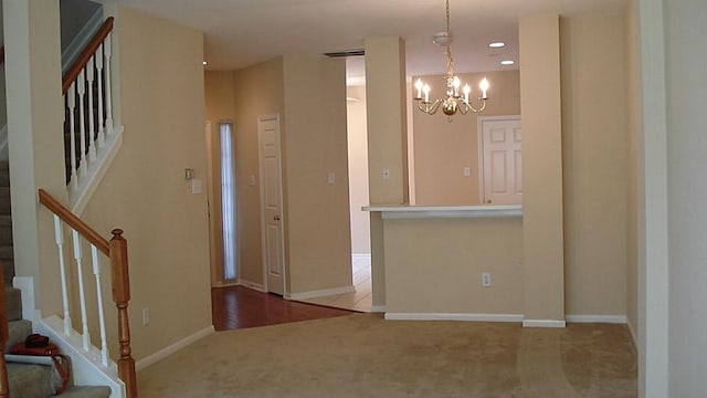 entryway featuring baseboards, stairway, carpet floors, recessed lighting, and an inviting chandelier