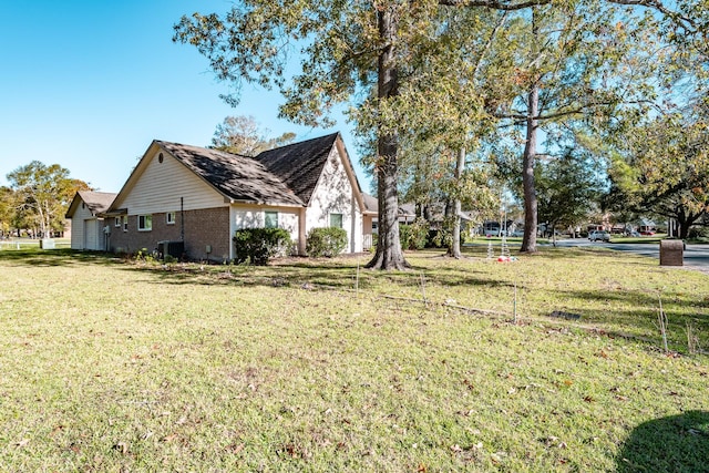 view of side of property with a lawn and brick siding