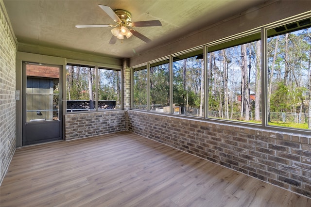 unfurnished sunroom with a ceiling fan