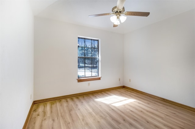 unfurnished room with light wood-style floors, baseboards, and ceiling fan