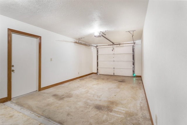 garage featuring a garage door opener and baseboards