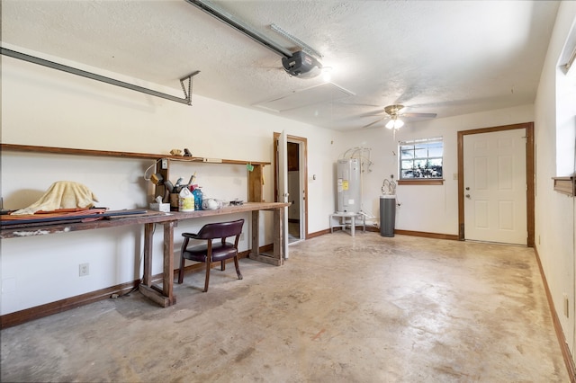 garage featuring baseboards, a garage door opener, and water heater