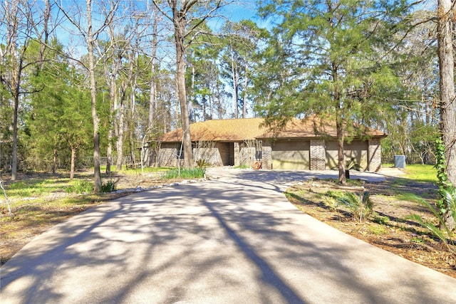 view of front of house featuring brick siding and driveway