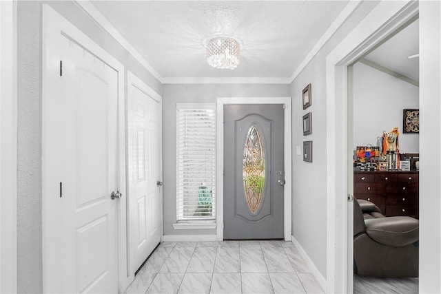 entrance foyer featuring a chandelier, baseboards, marble finish floor, and ornamental molding