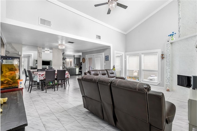 living room with visible vents, marble finish floor, high vaulted ceiling, and crown molding