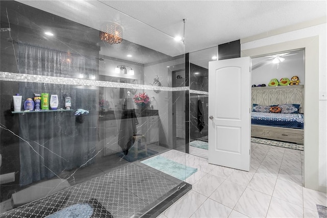 ensuite bathroom featuring a marble finish shower, marble finish floor, a textured ceiling, and ensuite bath