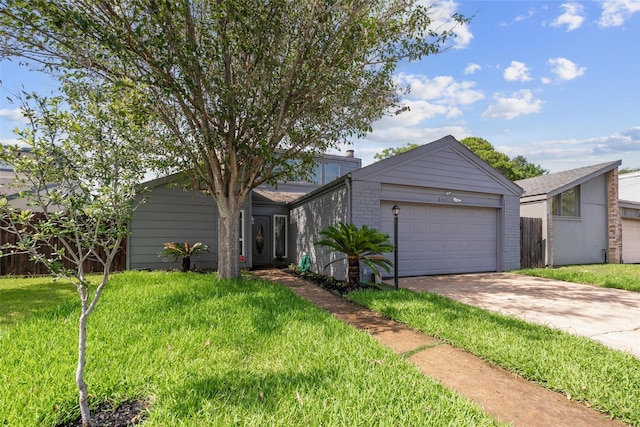 mid-century home featuring an attached garage, a chimney, concrete driveway, a front lawn, and brick siding