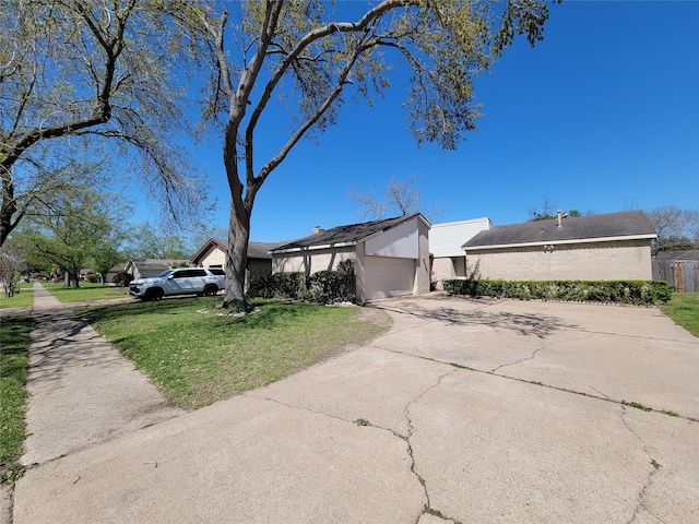 view of property exterior with driveway, a lawn, and an attached garage