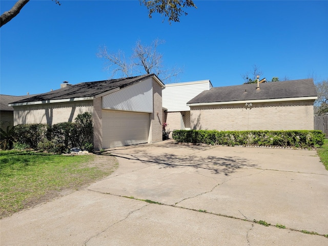 view of home's exterior with brick siding, driveway, and an attached garage