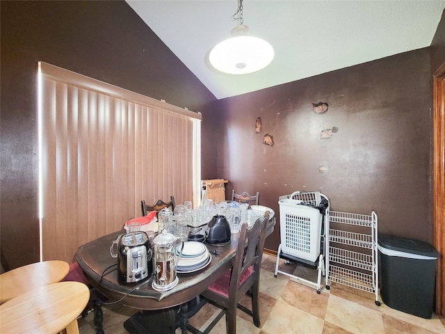 dining room featuring lofted ceiling