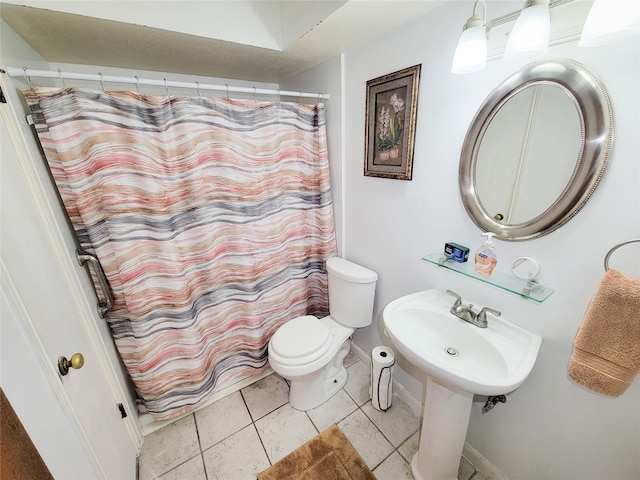 full bath with a shower with shower curtain, toilet, tile patterned floors, and a sink