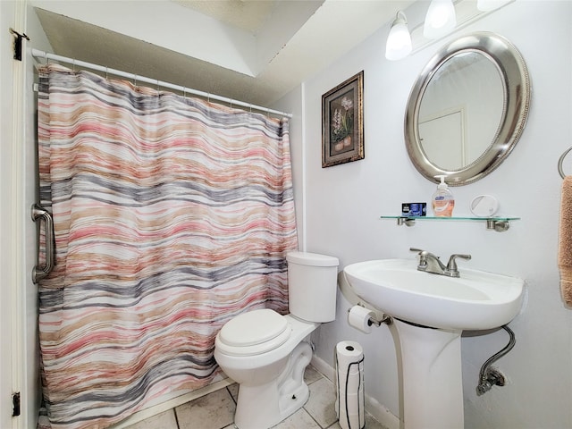 full bathroom with tile patterned flooring, curtained shower, toilet, and a sink