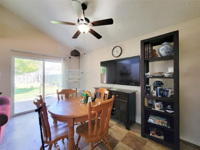 dining area featuring a textured ceiling, vaulted ceiling, and ceiling fan