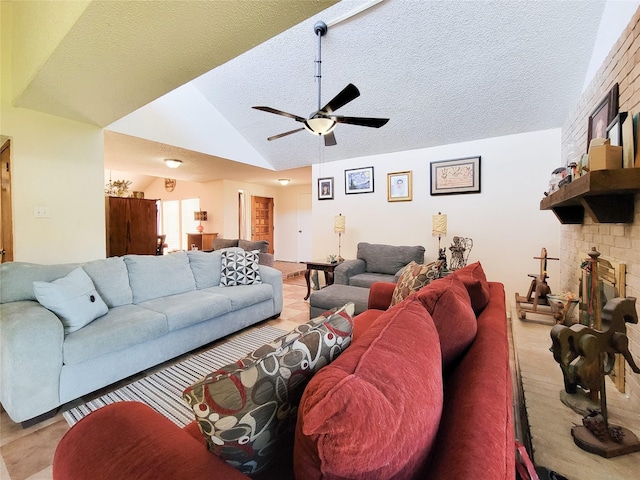 living room featuring a large fireplace, a textured ceiling, a ceiling fan, and vaulted ceiling