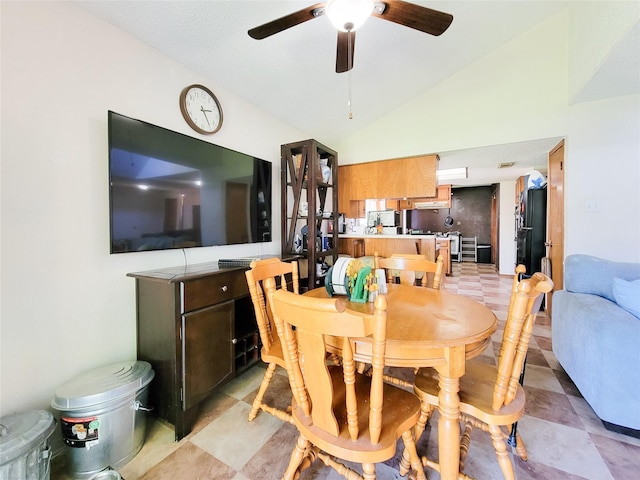 dining room featuring a ceiling fan and vaulted ceiling