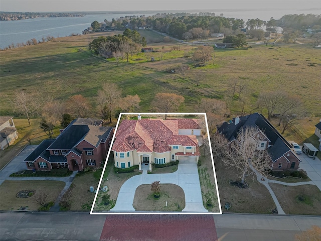 drone / aerial view with a rural view and a water view