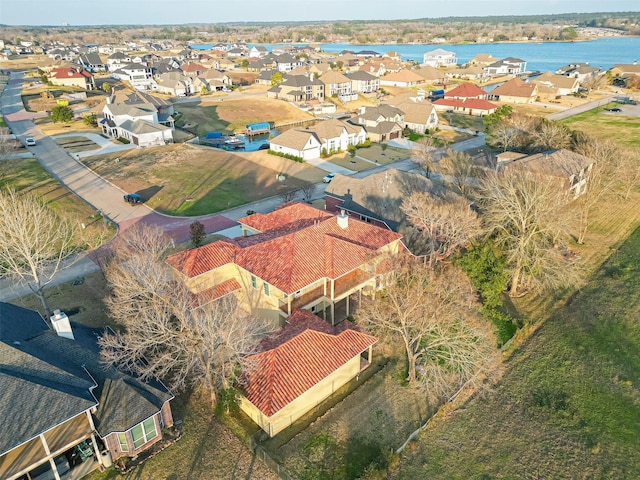 birds eye view of property featuring a residential view and a water view