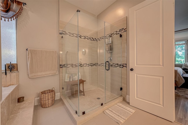 full bath with connected bathroom and a shower stall