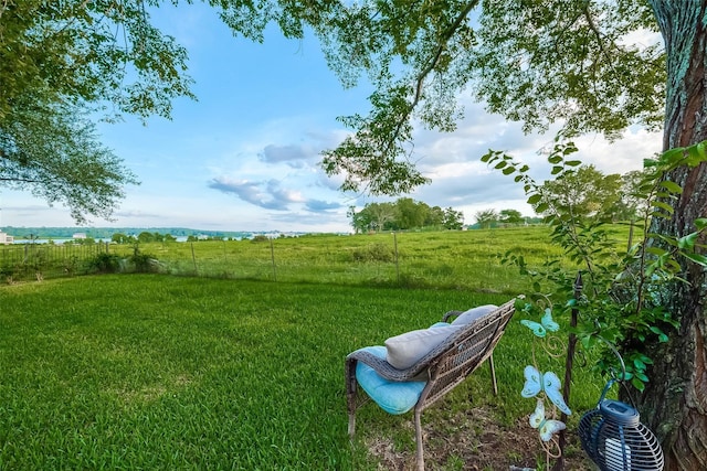 view of yard with a rural view and fence