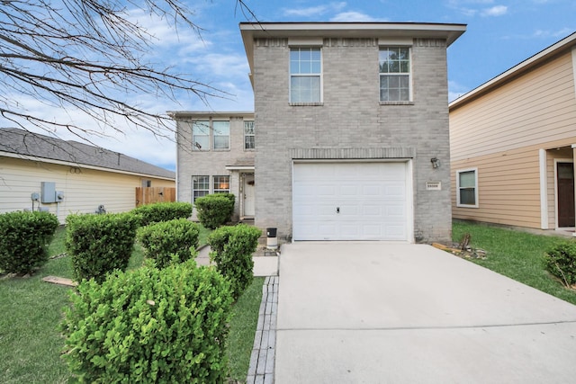 traditional home with brick siding, an attached garage, and driveway