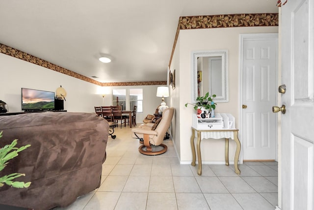 living room with baseboards and light tile patterned flooring