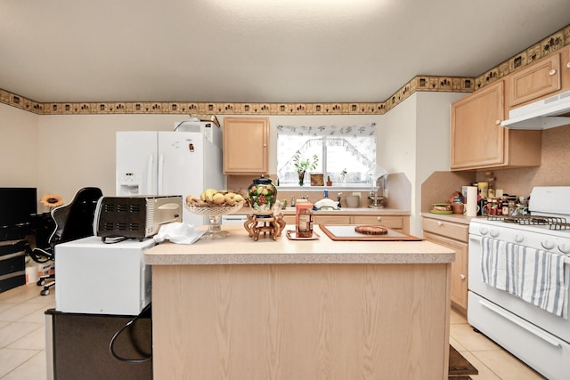 kitchen featuring a center island, light brown cabinetry, light countertops, light tile patterned floors, and white appliances