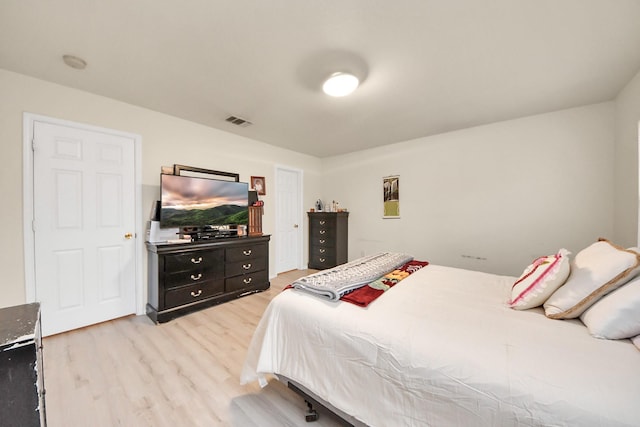 bedroom featuring light wood-style flooring and visible vents