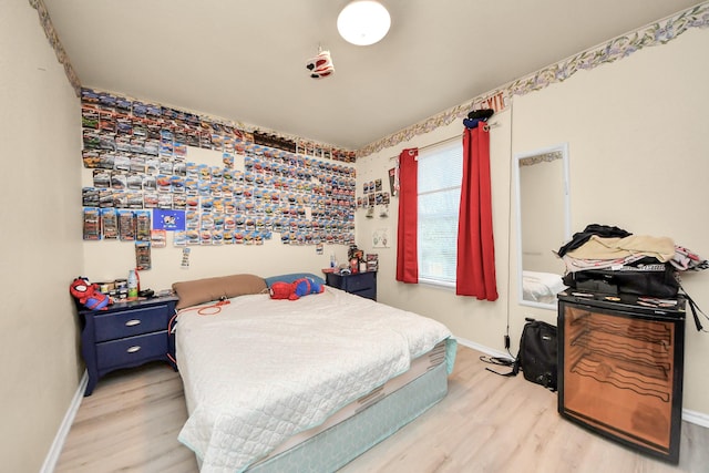 bedroom featuring light wood-type flooring and baseboards