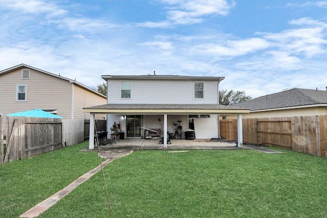 back of house with a yard, a shingled roof, a fenced backyard, and a patio area