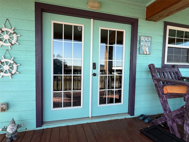 view of exterior entry featuring a porch and french doors