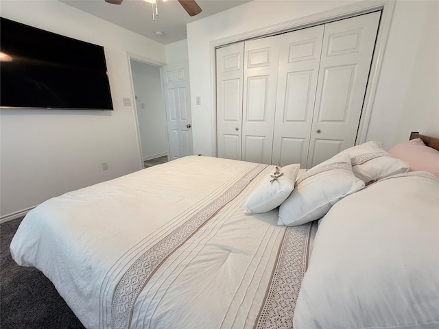 carpeted bedroom featuring a closet, baseboards, and a ceiling fan