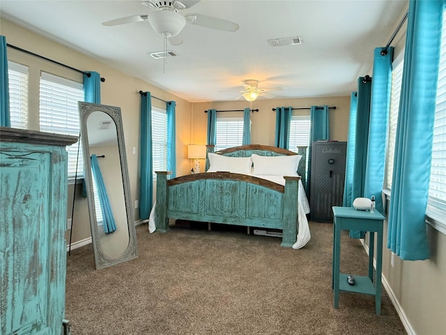 carpeted bedroom featuring baseboards, visible vents, and ceiling fan