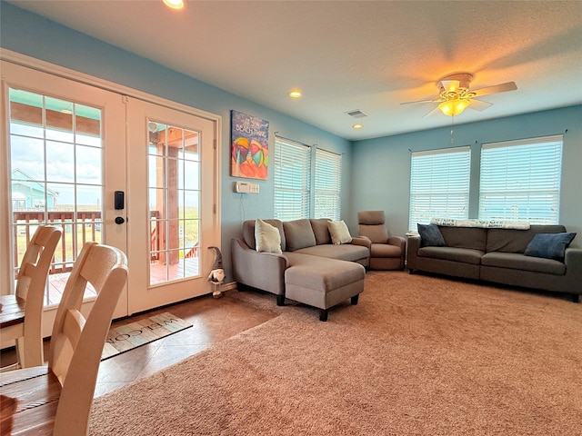 tiled living area with carpet, visible vents, a ceiling fan, recessed lighting, and french doors