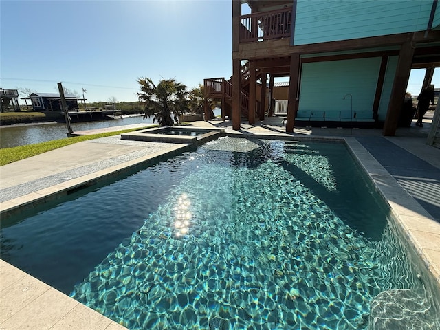 pool with a water view, stairs, and a patio area