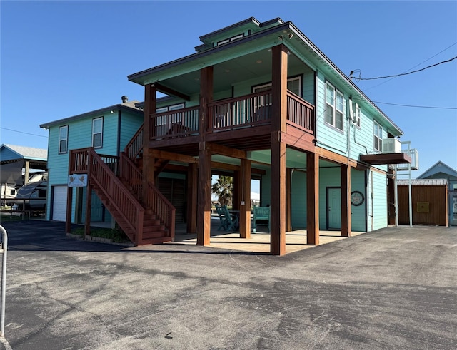 back of house featuring stairway and a patio area